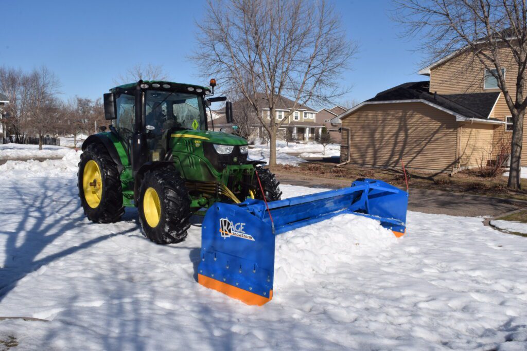 SnowStorm Tractor Snow Plow pushing snow