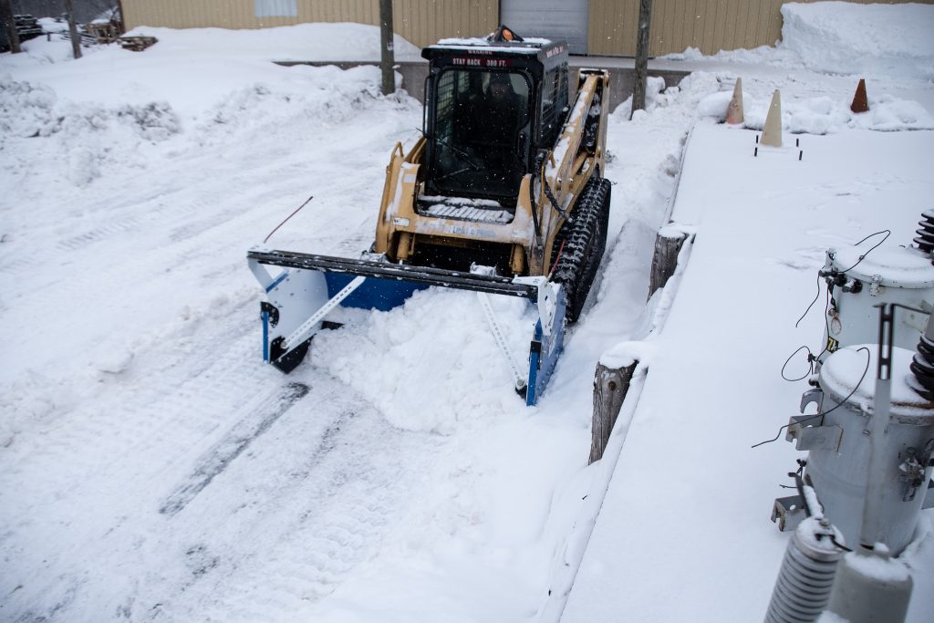 Utility Company Using a CTL to Clear Snow In Loading Dock