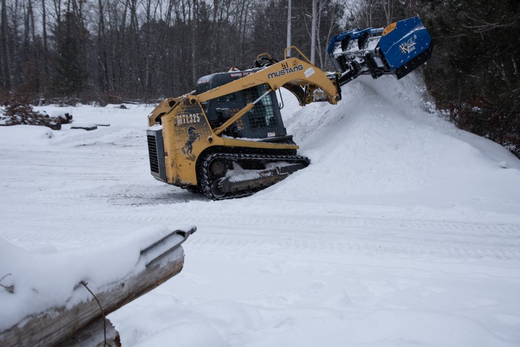Compact Track Loader Stacking Snow for Electricity Companies